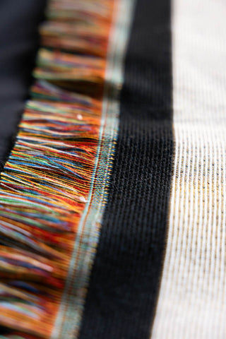 Colourful fringe detailing on the Monochrome Forever Rebel Woven Throw.