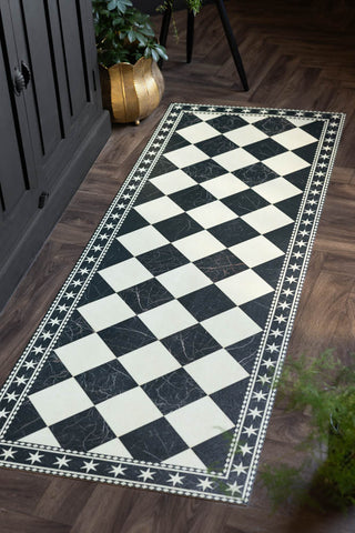 Monochrome Marble Tile Effect Durable Runner shown against dark wood floors and a black cabinet.
