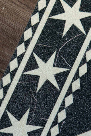 Image shows the the vinyl texture on the star border of the Monochrome Marble Tile Effect Durable Runner. 