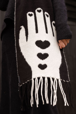 The white hand detailing on the monochrome black scarf