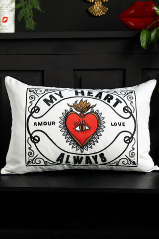 The My Heart Monochrome Embroidered Cushion shown on a black wooden bench. 