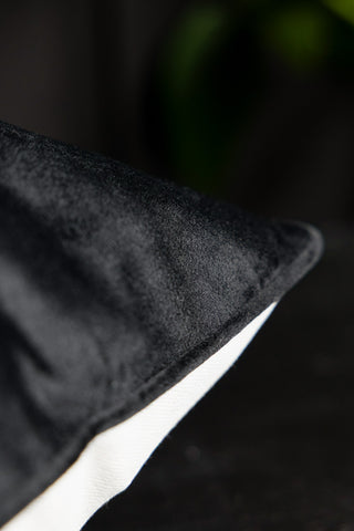 Detail showing the black piping and plain black fabric on the back of the cushion. 