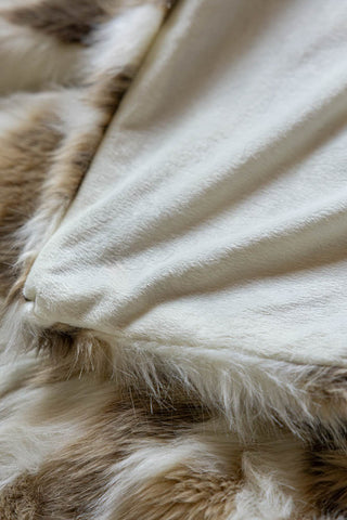 The soft underside of the Natural Abstract Faux Fur Throw. 