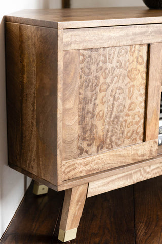 The side of the Natural Leopard Print Corner TV Unit, showing the gold tipped legs and detailing of the sliding door. 