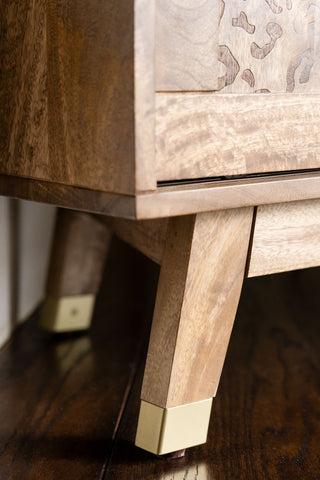 The gold tipped feet of the Natural Leopard Print Corner TV Unit.