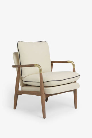 Natural armchair with wooden frame and gold accents on a white background.