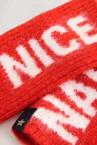 Close-up of the text on the Naughty or Nice Handwarmers, laid together and displayed on a white background.