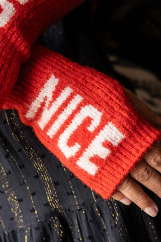 Close-up of the 'nice' handwarmer of the Naughty or Nice Handwarmers being worn by a model.