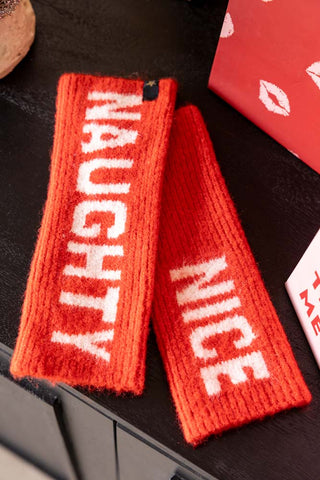 The Naughty or Nice Handwarmers displayed on a dark surface.