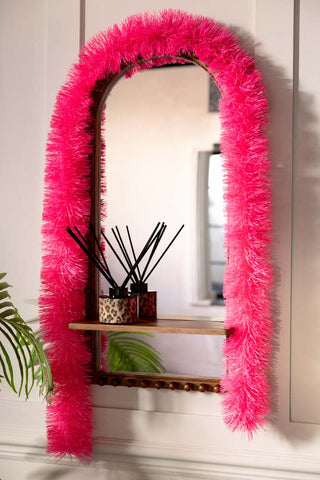 The Neon Pink Tinsel styled around a mirror.