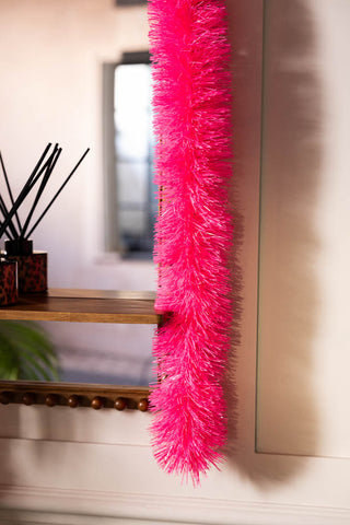 Close-up of the Neon Pink Tinsel styled on a mirror.