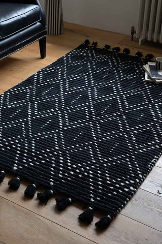 Lifestyle image of the Black & Cream Diamond Rug With Tassels - 3 Sizes Available