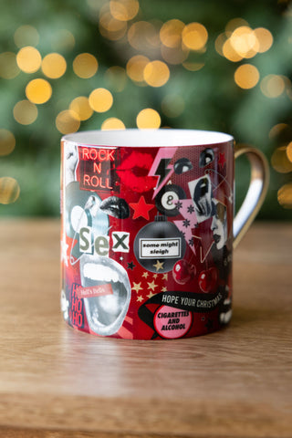 The Never Mind The Baubles Mug displayed on a wooden surface.