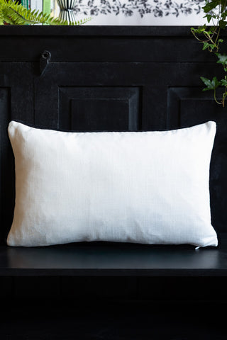 Image of the back of the Normal Is Boring Embroidered Rectangular Cushion