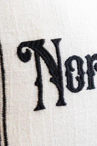 Image of the material on the Normal Is Boring Embroidered Rectangular Cushion