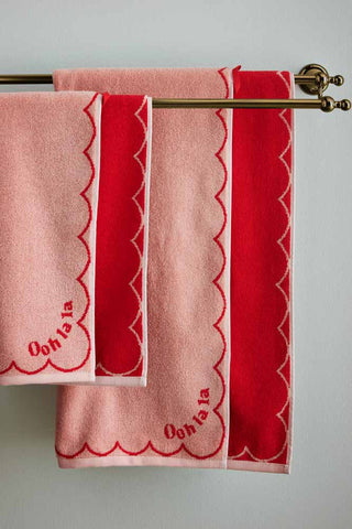 Close-up image of the Ooh La La Bath Towel and Ooh La La Hand Towel displayed on a towel rail on the wall.