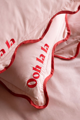 Close-up of the text on the pillowcases from the Ooh La La Pink & Red Scallop Edge Bedding Set.
