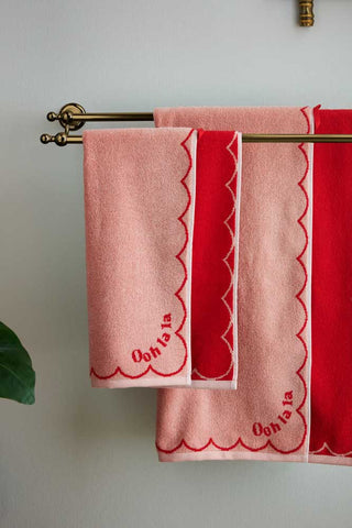The Ooh La La Hand Towel and Ooh La La Bath Towel displayed on a towel rail on the wall.