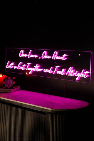 Lifestyle image of the One Love One Heart Neon Wall Light