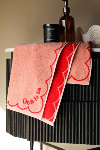 Image of the Ooh La La Hand Towel styled on a black side table