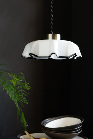 Image of the Monochrome Pleated Glass Easyfit Ceiling Light Shade shown in a kitchen against black walls with bowls in the shot. 