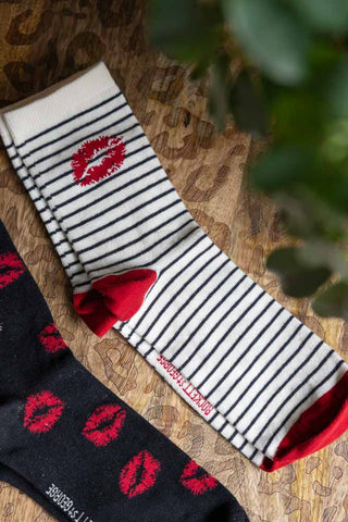 Some of the socks from the Pack Of 4 Lips Printed Socks on a leopard print surface.