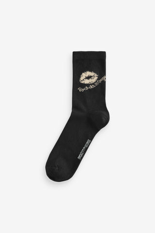 A pair of black socks with lips design on a white background.