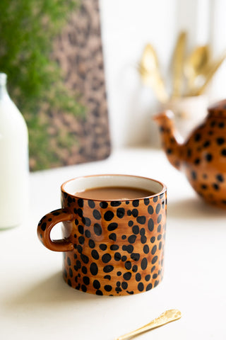 Lifestyle image of the Painted Leopard Print Mug