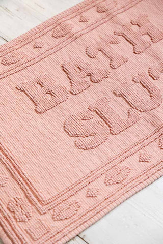 Detail of the Bath Slut Blush Pink Bath Mat. 