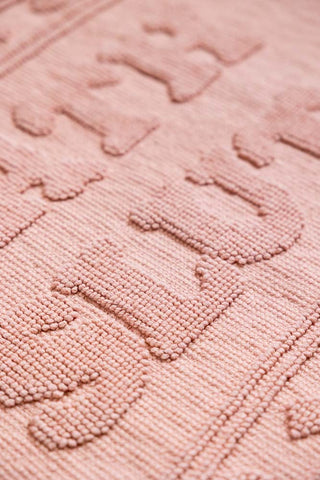 Close up showing the textured slogan on the Bath Slut Blush Pink Bath Mat. 