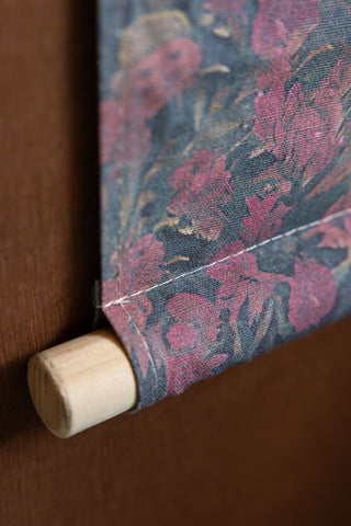 Close-up of the wooen rod at the bottom of the Palm Tree Canvas Wall Hanging.