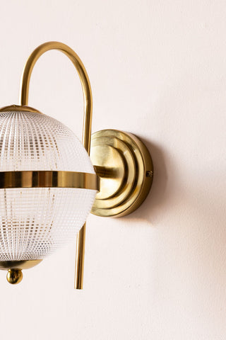 Image of the Parisian Gold & Glass Globe Wall Light on a wall