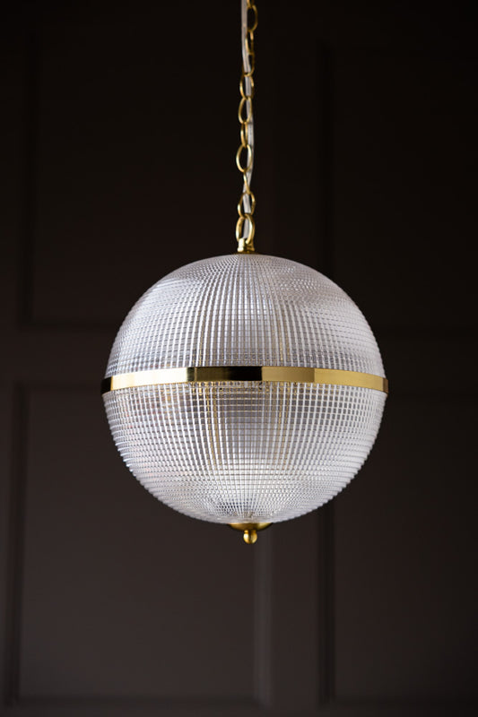 The Parisian Gold & Glass Pendant Ceiling Light in front of a black wall.