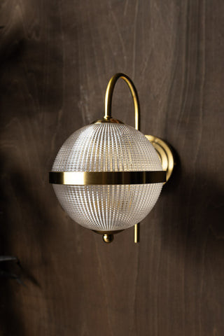 Lifestyle image of the Parisian Gold & Glass Globe Wall Light