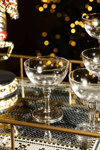 A glass shown on the top of the party people drinks trolley. 