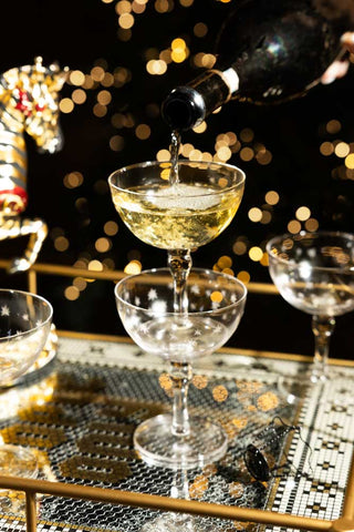 The Party People Only Gold Drinks Trolley, shown with a champagne drinks tower. 