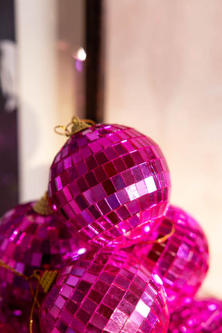 Close-up of a display of Pink Disco Ball Christmas Tree Decorations.