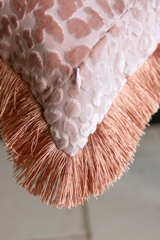 Close-up of the zip and fringing on the Blush Pink Leopard Velvet Cushion with Fringe Trim.