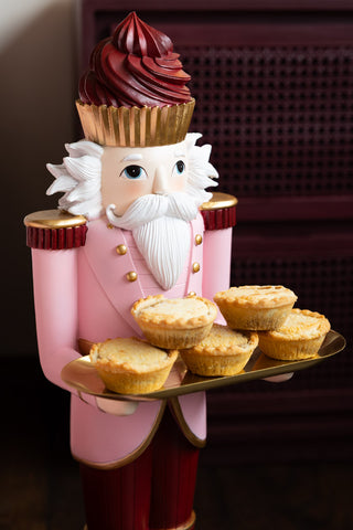The Pink Nutcracker Butler Christmas Decoration styled with some mince pies on.