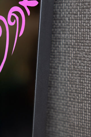 The edge of the Pink Ornate Print Frame Mirror. 
