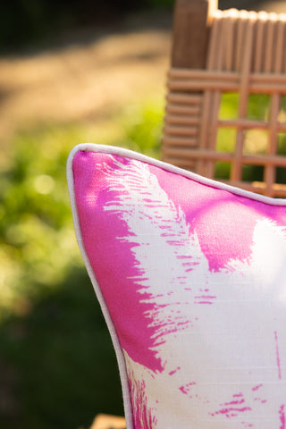 Close-up of the corner of the Pink Palm Tree Outdoor Cushion.