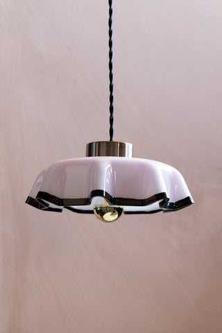 The Pink Pleated Glass Easyfit Ceiling Light Shade shown against neutral plastic pink walls. 