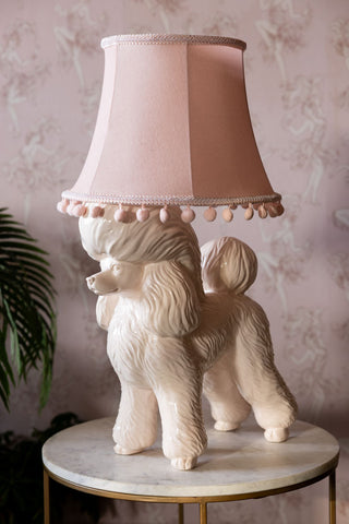 The Pink Poodle Table Lamp styled on a table.
