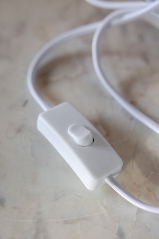 Close-up of the rocker switch of the Pink Poodle Table Lamp.