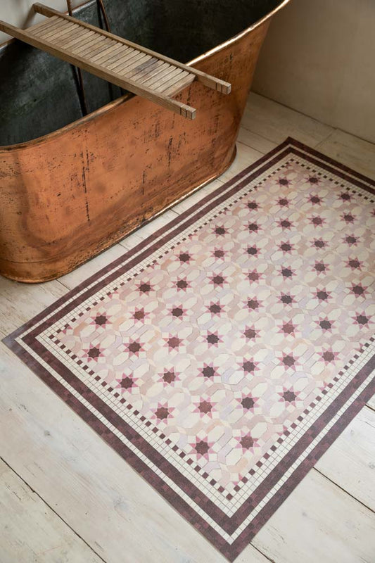 Pink Star Durable Floor Mat shown in a bathroom next to a copper bath.
