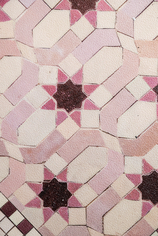 A close up of the pattern on the Pink Star Durable Runner, showing the star tile-inspired design and pink and burgundy palette. 