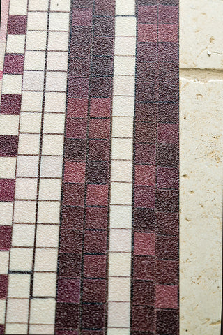 The tile-effect edge border of the Pink Star Durable Floor Mat. 