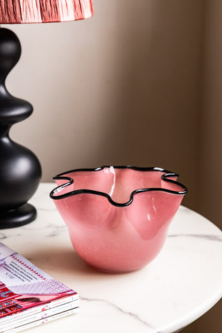 Image of the Pink Wavy Decorative Glass Bowl on a side table