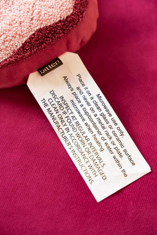Image of the label on the Pink & Red Bow Shape Microwaveable Wheat Bag