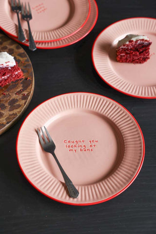 The Pink & Red First Bite Side Plates Set of 4 displayed with forks, cake and a serving board on a dark wooden table.